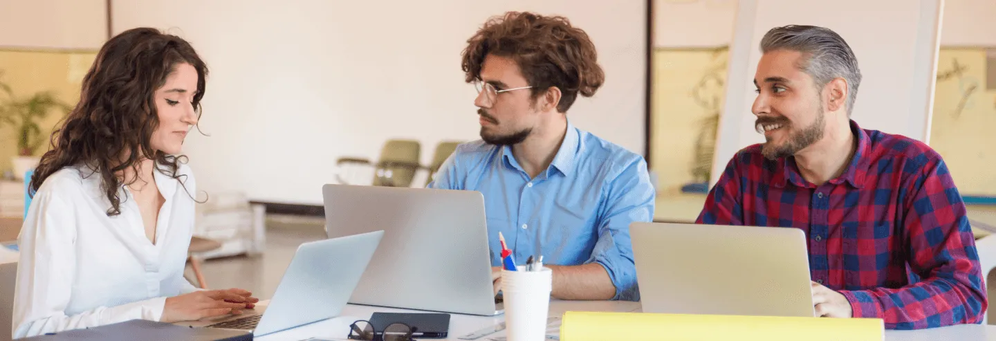people with laptops in a meeting