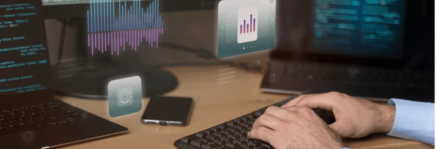 hands typing with three screens